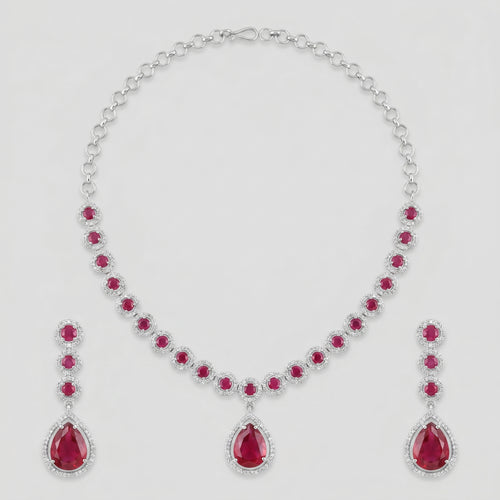 Aira Ruby Necklace Set silver-tone ruby collar choker with matching drop earrings on gray background