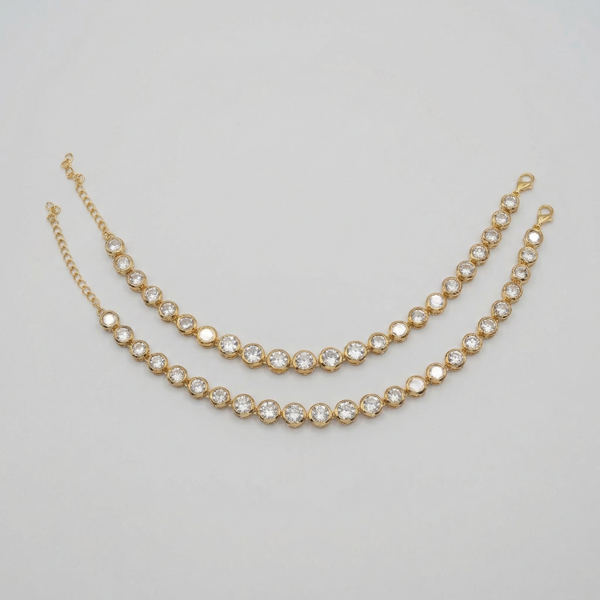 Jyoti Anklet pair of gold-tone round crystal tennis payals with extender chain