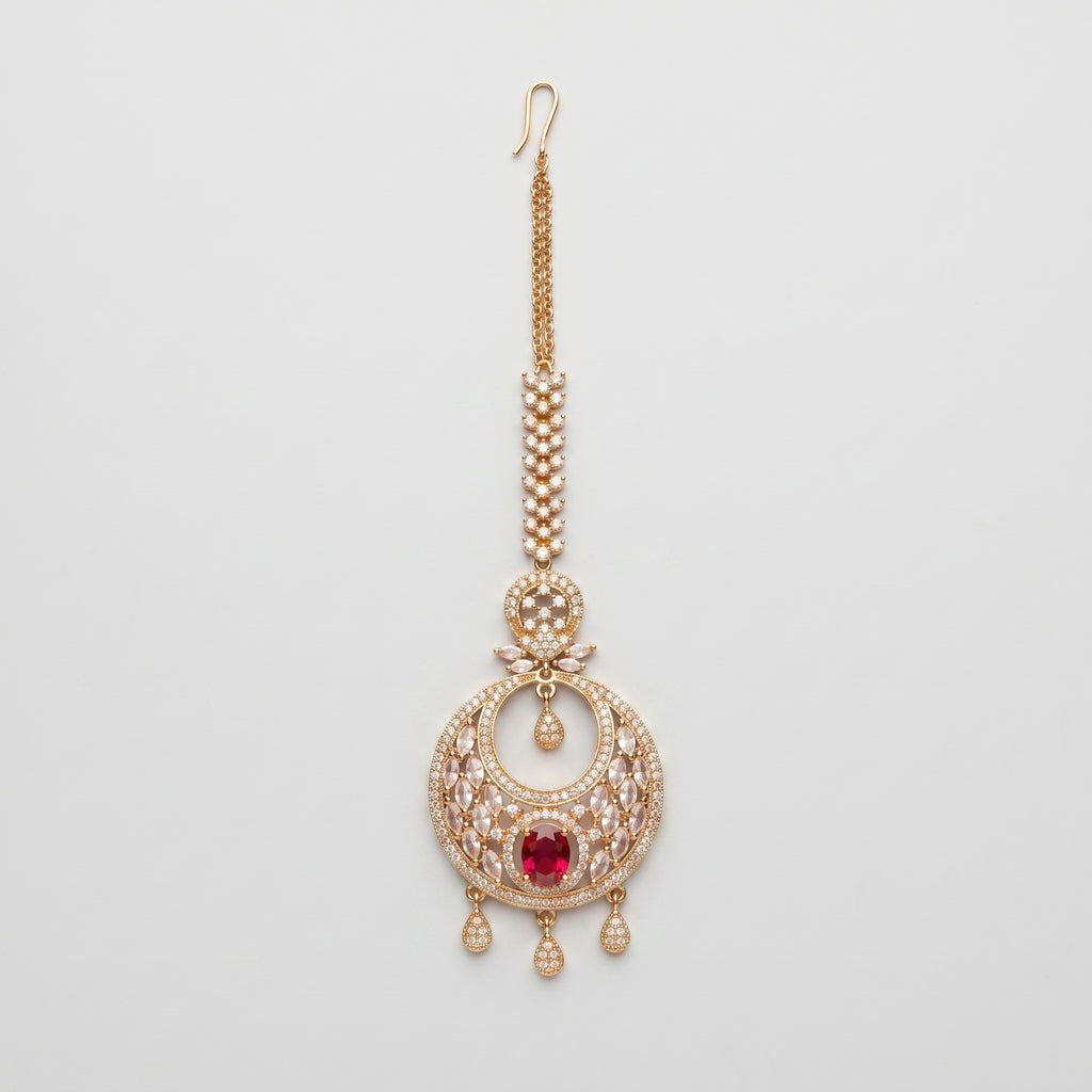 Ruby Tikka gold chandbali maang tikka with ruby red oval center on gray background