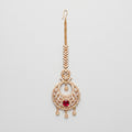 Ruby Tikka gold chandbali maang tikka with ruby red oval center on gray background