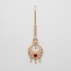 Ruby Tikka gold chandbali maang tikka with ruby red oval center on gray background