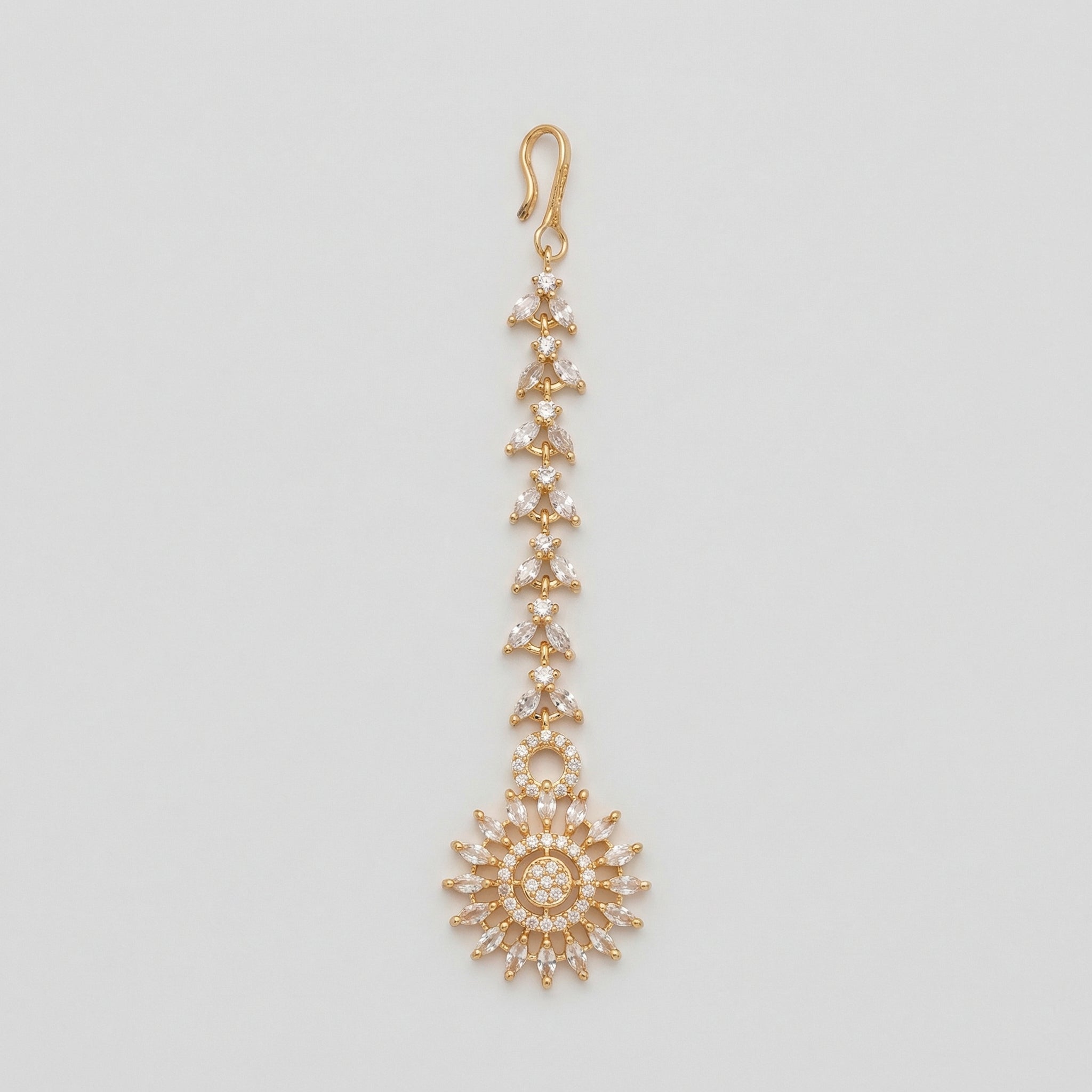 Kiran Tikka gold-tone marquise chain maang tikka with round sunburst crystal pendant on gray background