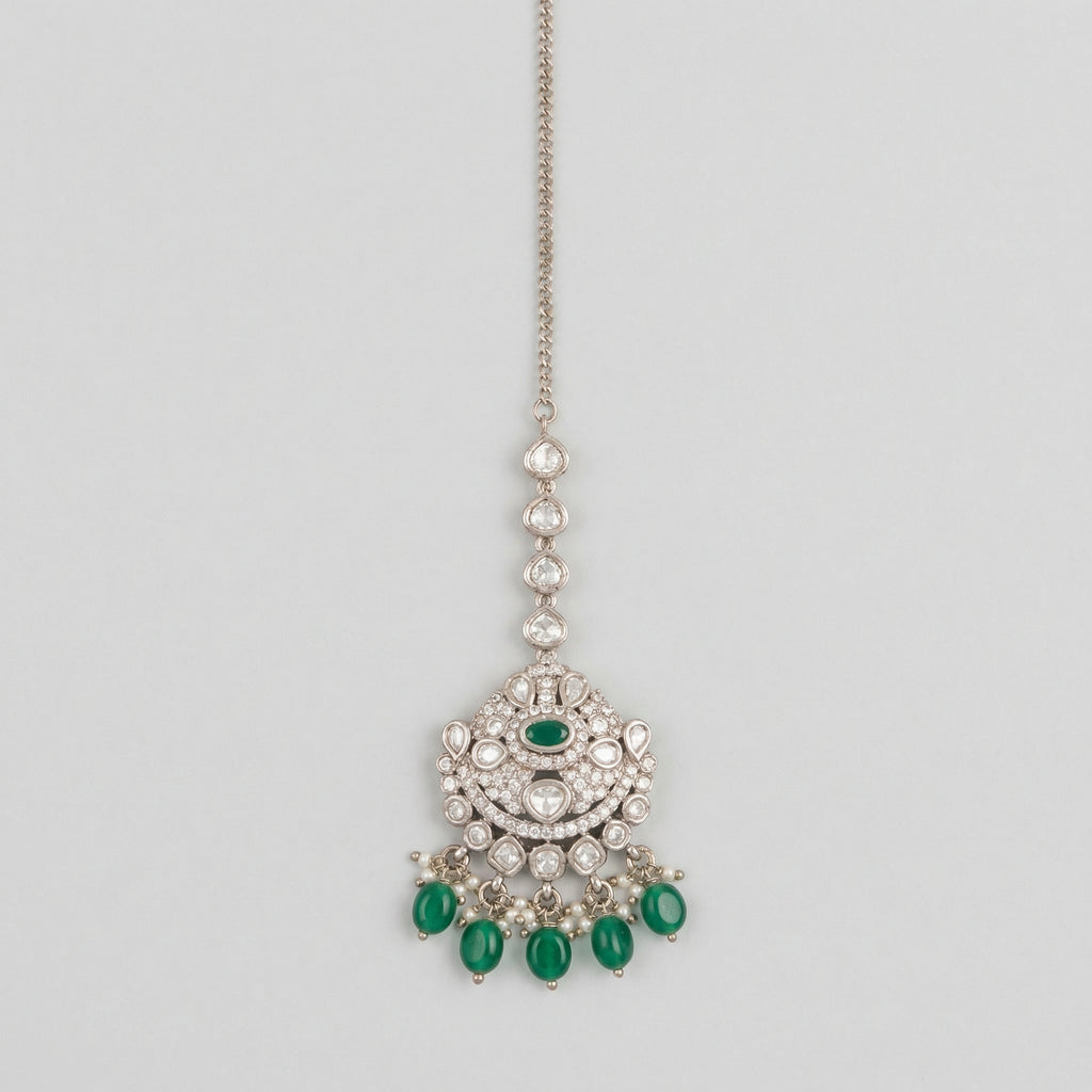 Noor Emerald Tikka silver maang tikka with green center stone and green teardrop bead fringe on gray background