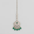 Noor Emerald Tikka silver maang tikka with green center stone and green teardrop bead fringe on gray background