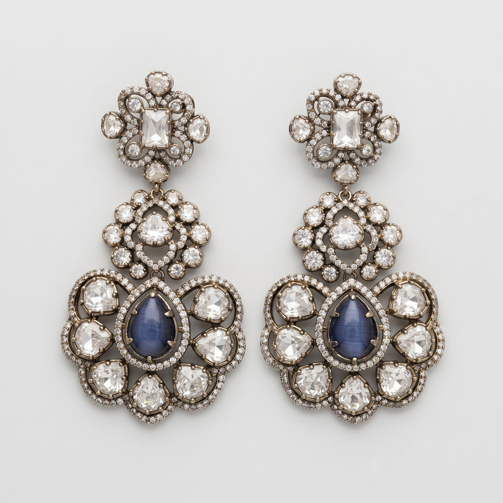 Neelam Bloom Earrings oxidized silver chandelier drops with blue cat's eye pear stones on gray background