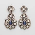 Neelam Bloom Earrings oxidized silver chandelier drops with blue cat's eye pear stones on gray background