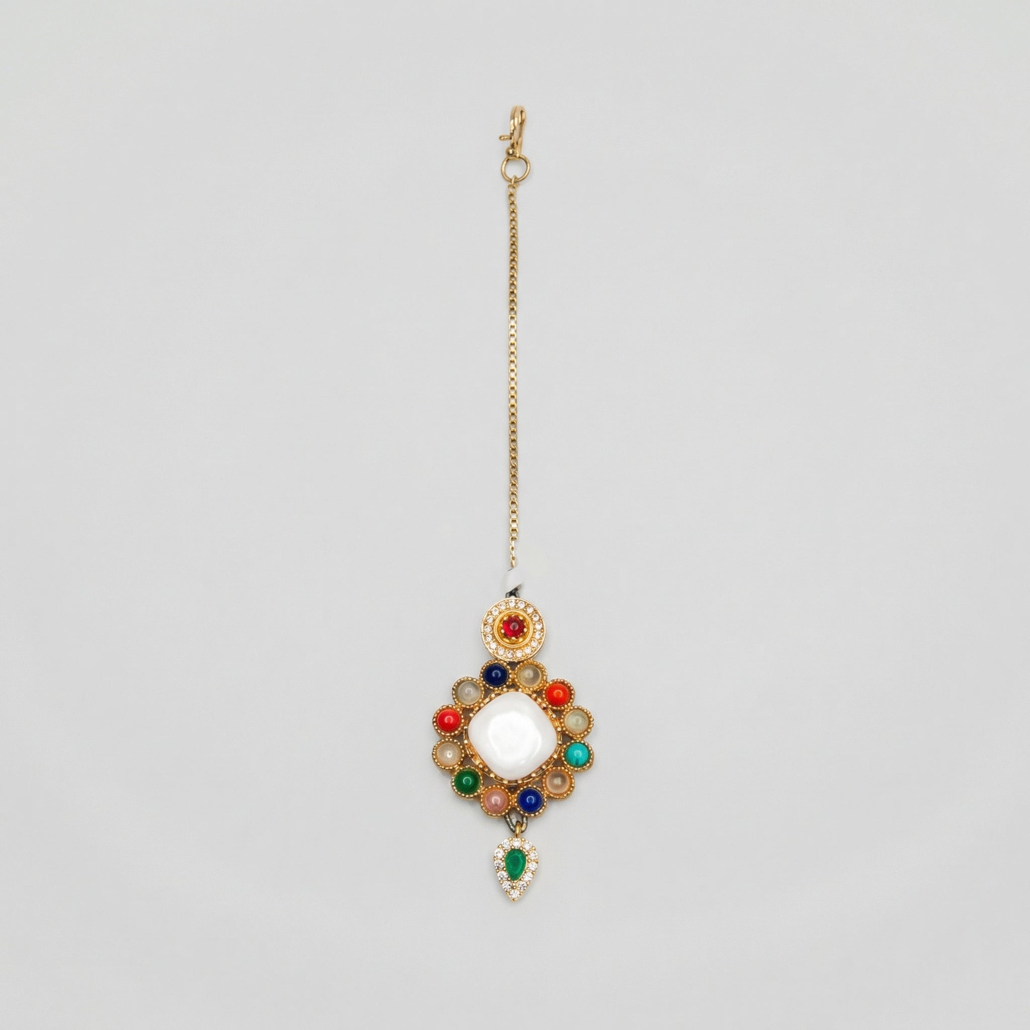 Rangoli Moti Tikka gold maang tikka with multicolor navratna circle and green teardrop drop on gray background
