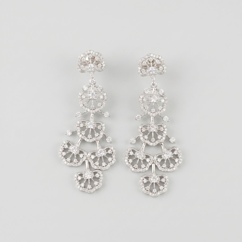 Noor Cascade Earrings rhodium-plated tiered crystal pavé chandelier fans on gray background