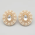 Kundan Pearl Earrings gold kundan studs with clear center and pearl crystal border on gray background