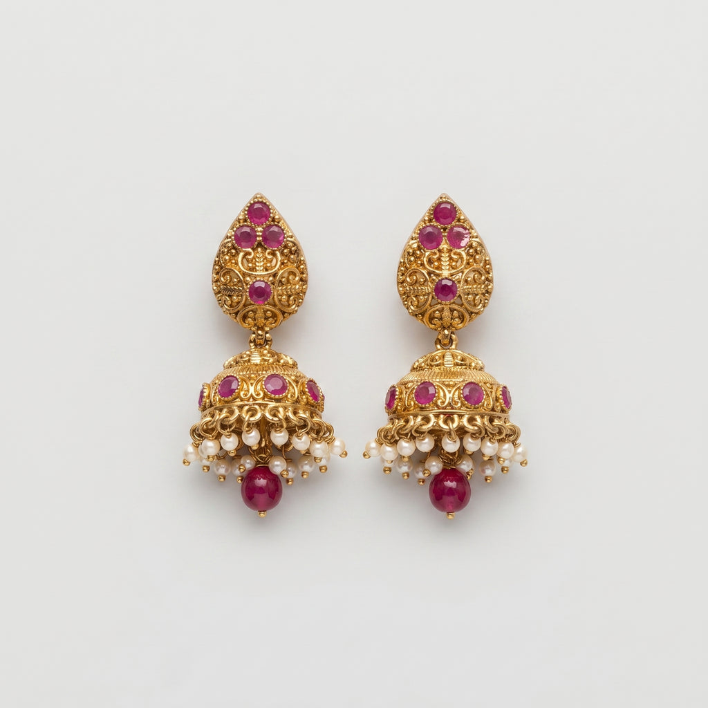 Ruby Pearl Earrings gold jhumka drops with ruby stones and pearl fringe on gray background