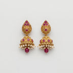 Ruby Pearl Earrings gold jhumka drops with ruby stones and pearl fringe on gray background