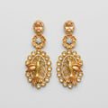 Hansini Drop Earrings matte gold-tone bird motif drop earrings on gray background