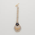 Rani Sapphire Tikka dual-tone maang tikka with blue floral accent and crescent crystal pendant on gray background