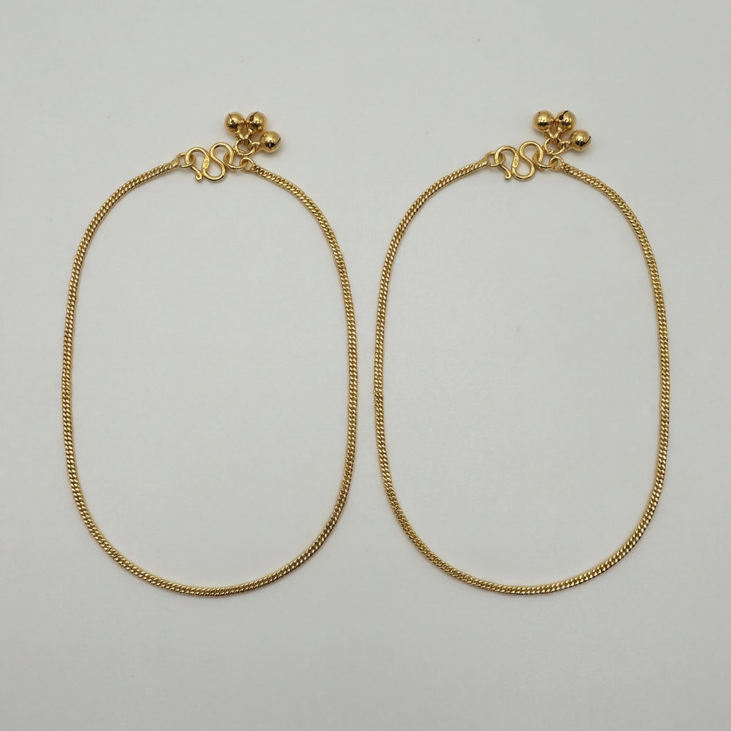 Sutra Anklet pair of gold-tone curb chain payals with ball charms on white background