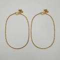 Sutra Anklet pair of gold-tone curb chain payals with ball charms on white background