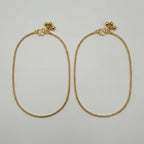 Sutra Anklet pair of gold-tone curb chain payals with ball charms on white background