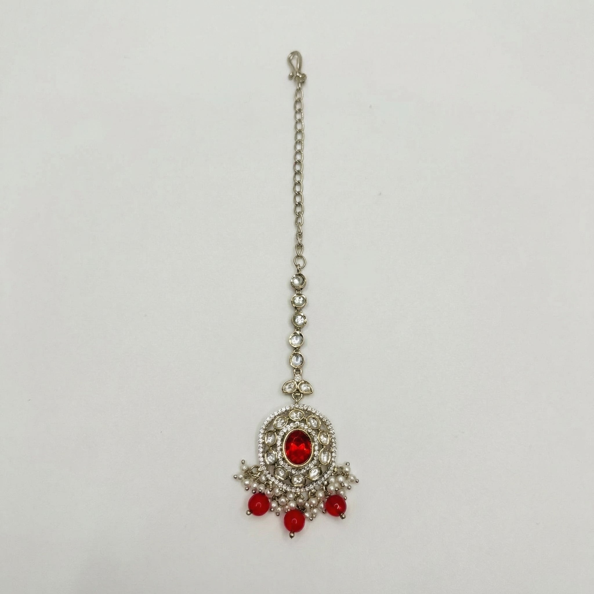 Ruby Bloom Tikka silver maang tikka with red oval center and red bead pearl fringe on white background