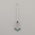 Sia Emerald Tikka silver maang tikka with green stones and chaandbali pendant on gray background