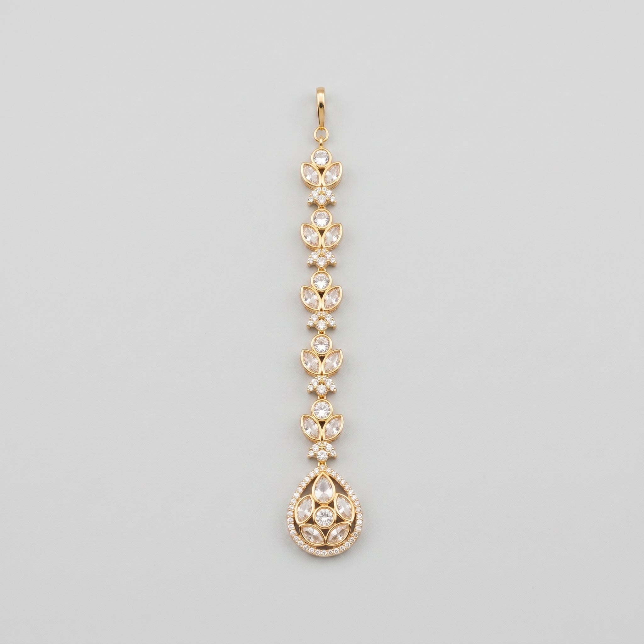 Kundan Crystal Tikka gold maang tikka with clear crystal chain and teardrop pendant on gray background