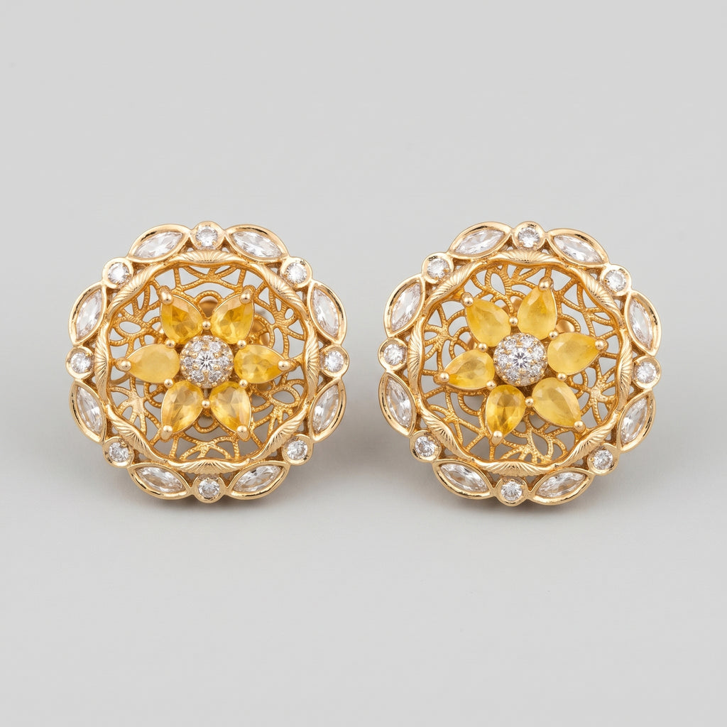 Surajmukhi Earrings gold sunflower studs with yellow pear petals and crystal border on gray background