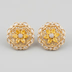 Surajmukhi Earrings gold sunflower studs with yellow pear petals and crystal border on gray background