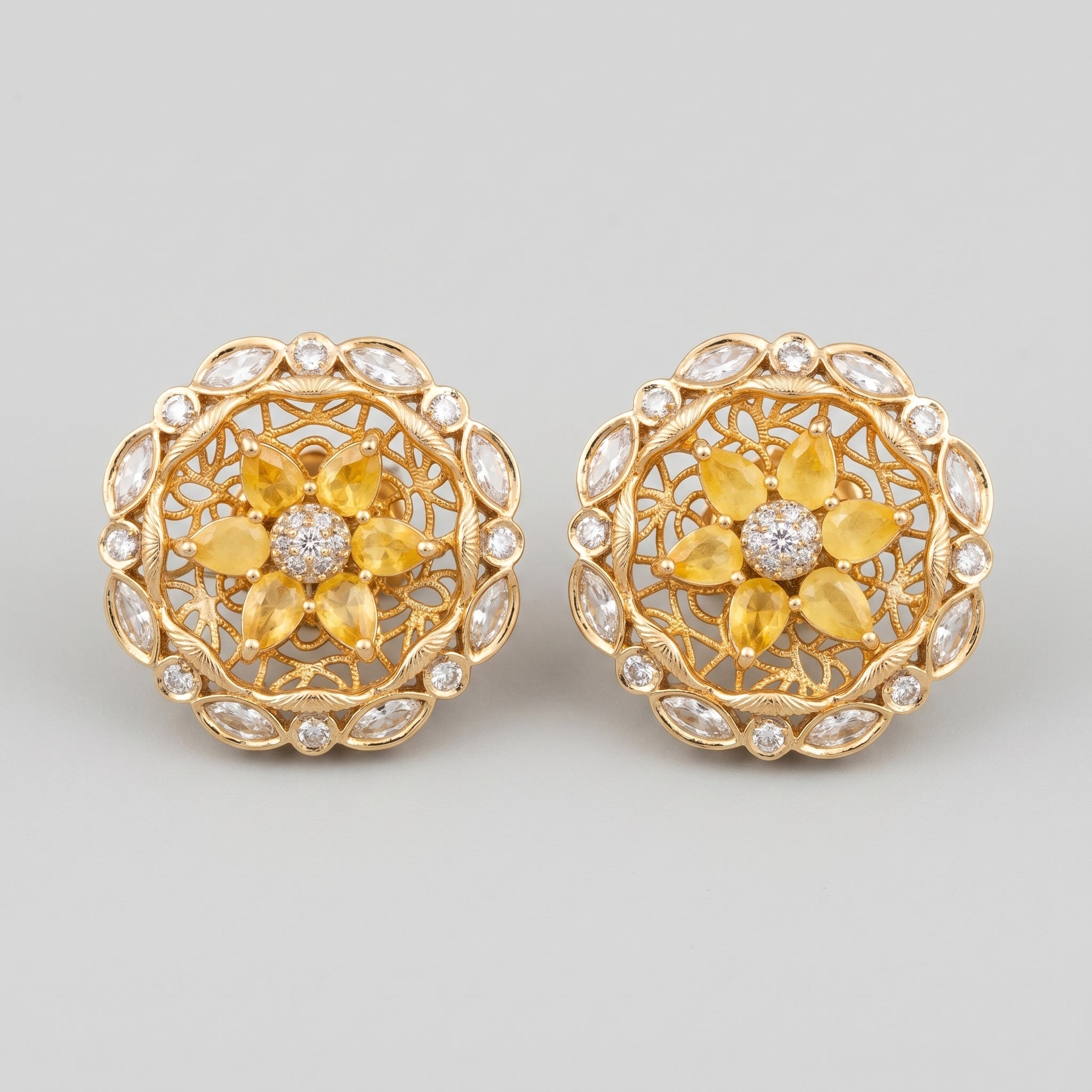Surajmukhi Earrings gold sunflower studs with yellow pear petals and crystal border on gray background