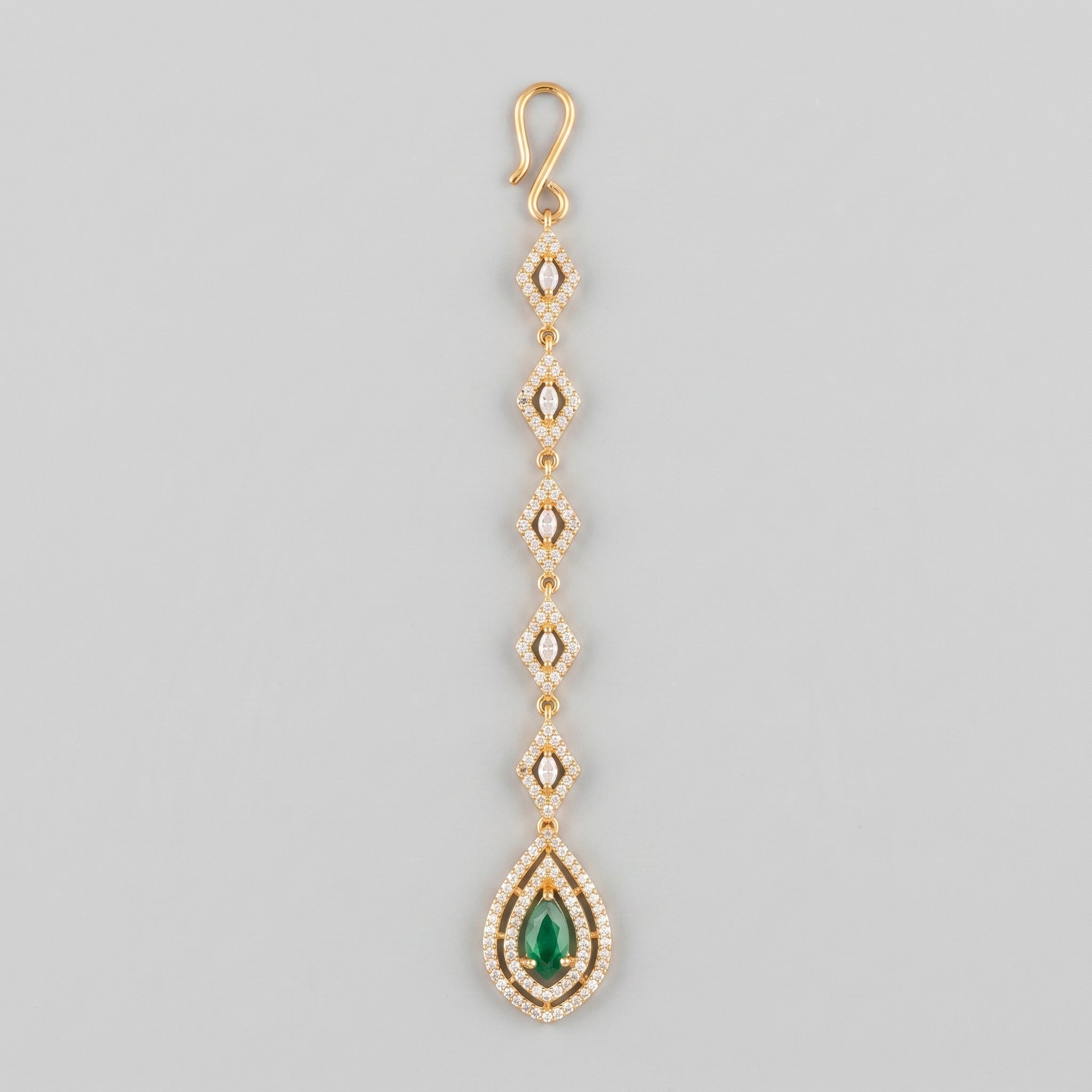 Priya Emerald Tikka gold-tone maang tikka with rhombus links and green teardrop pendant on gray background