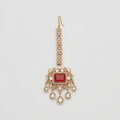 Kundan Ruby Tikka gold maang tikka with ruby red center and five teardrop crystal dangles on gray background