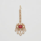Kundan Ruby Tikka gold maang tikka with ruby red center and five teardrop crystal dangles on gray background