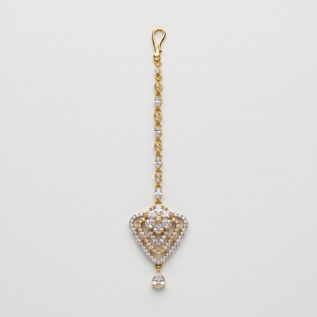 Golden Flora Tikka gold-tone floral heart maang tikka with teardrop chain on gray background