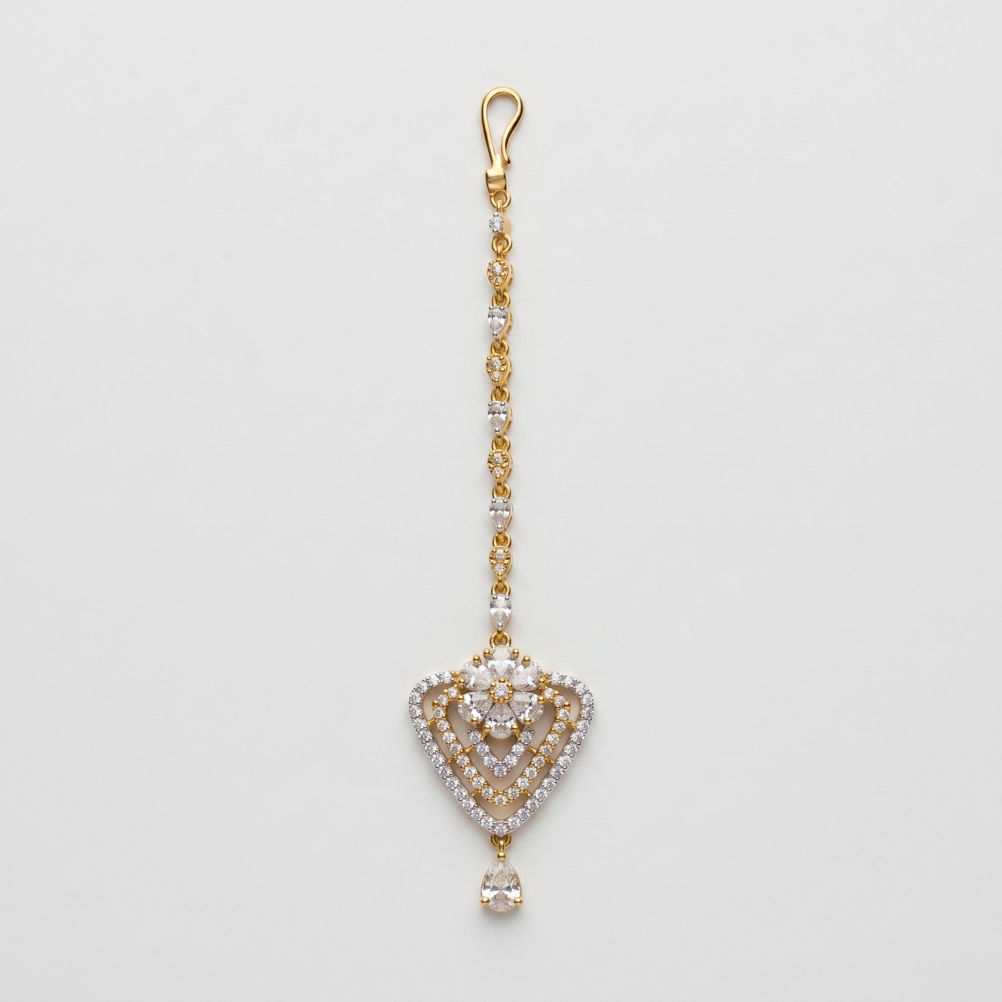 Golden Flora Tikka gold-tone floral heart maang tikka with teardrop chain on gray background