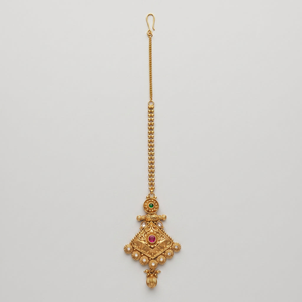 Jadau Ruby Tikka antique gold jadau maang tikka with ruby center on gray background