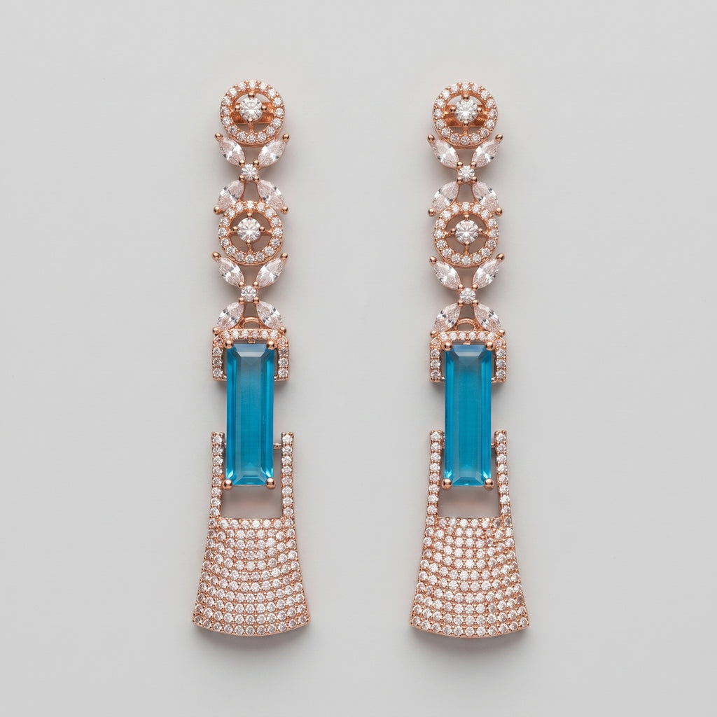 Rani Firoza Earrings rose gold-tone long drops with blue emerald-cut centers on gray background