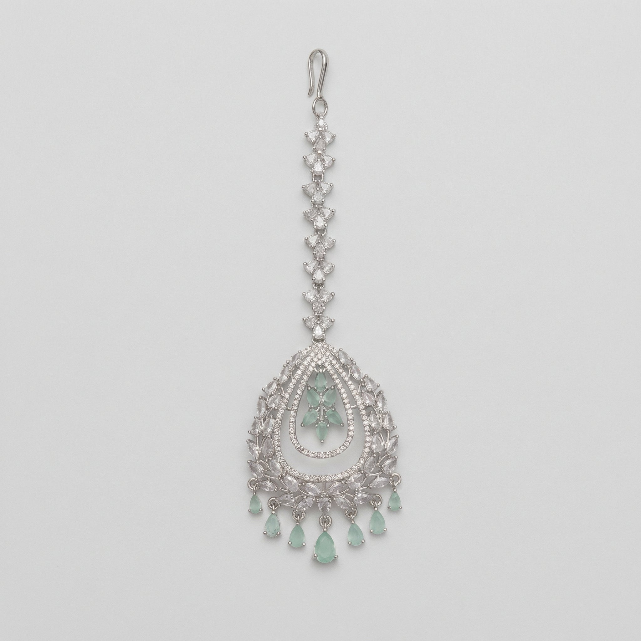 Zara Mint Tikka silver maang tikka with mint green center and teardrop dangles on gray background