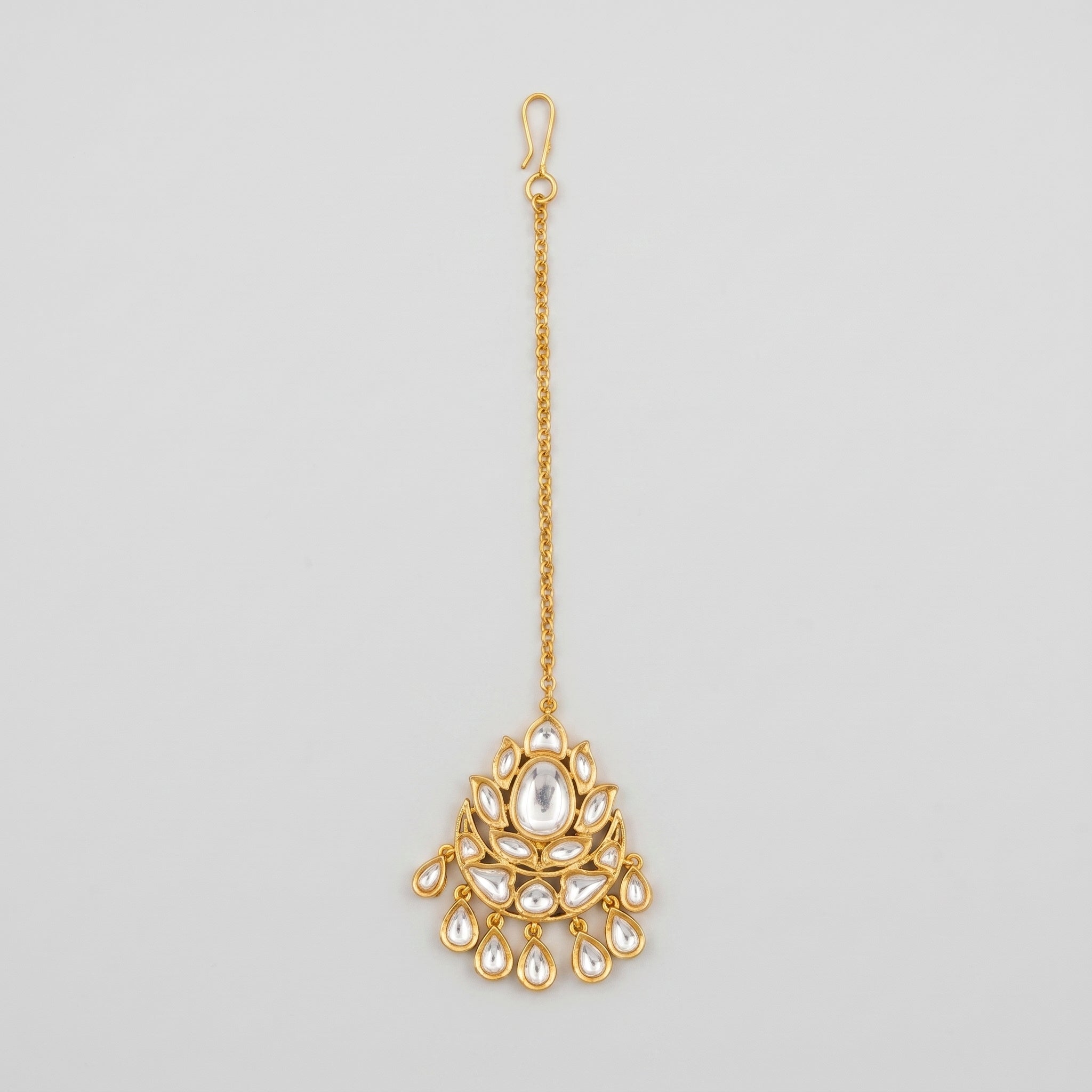 Jadau Polki Tikka gold maang tikka with floral kundan centerpiece and seven teardrop dangles on gray background