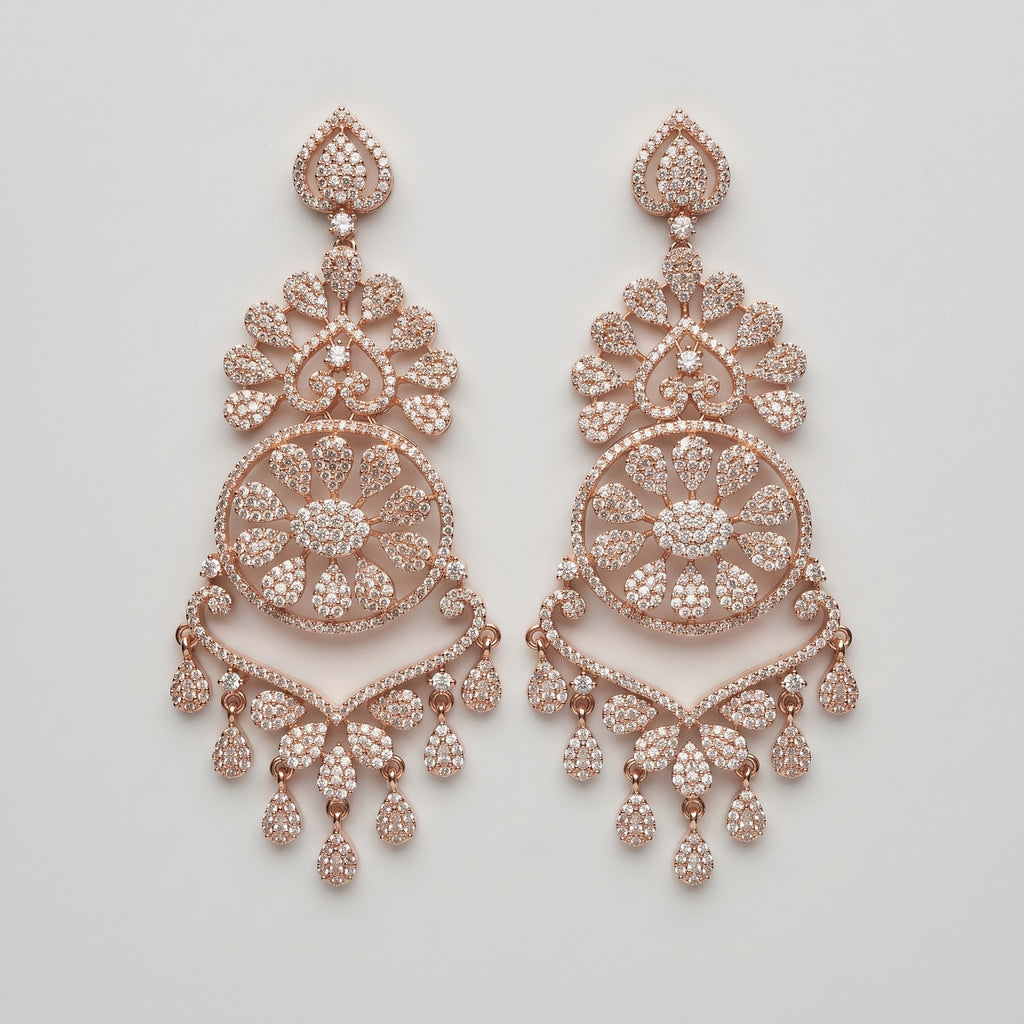 Roshni Earrings rose-gold chandelier drops with filigree medallion and crystal teardrop fringe on gray background