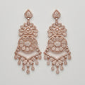 Roshni Earrings rose-gold chandelier drops with filigree medallion and crystal teardrop fringe on gray background