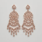 Roshni Earrings rose-gold chandelier drops with filigree medallion and crystal teardrop fringe on gray background