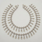 Sia Filigree Anklet pair of silver-tone filigree pearl payals arranged in a circle