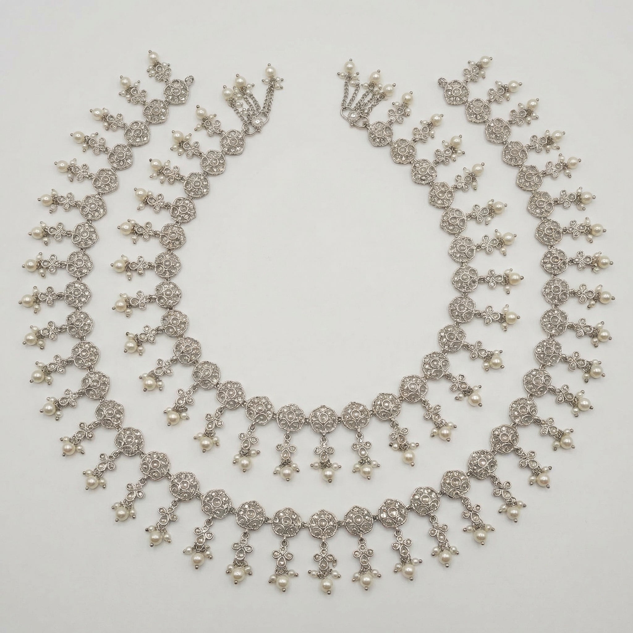 Sia Filigree Anklet pair of silver-tone filigree pearl payals arranged in a circle