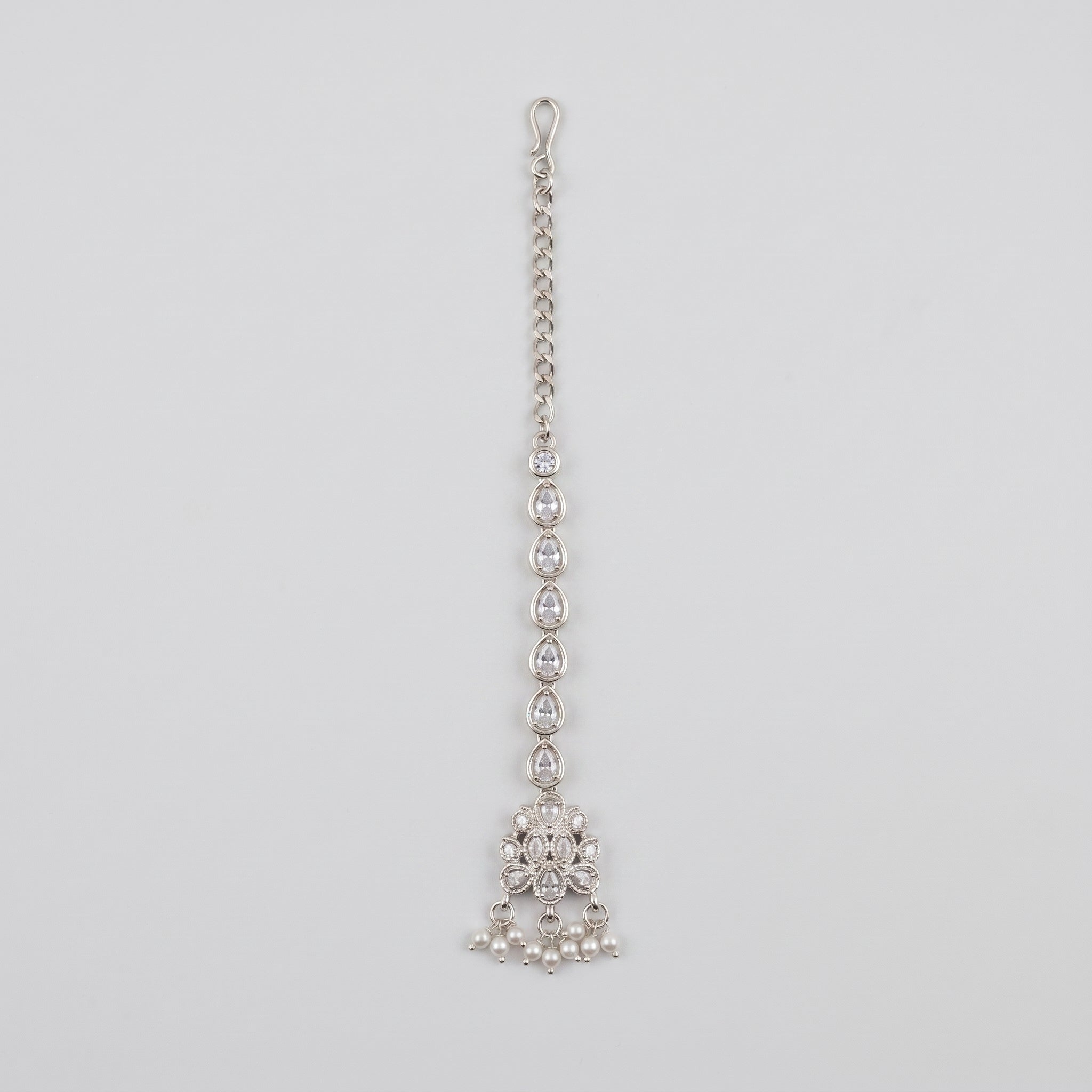Zara Crystal Tikka silver-tone maang tikka with teardrop chain and pearl fringe on gray background