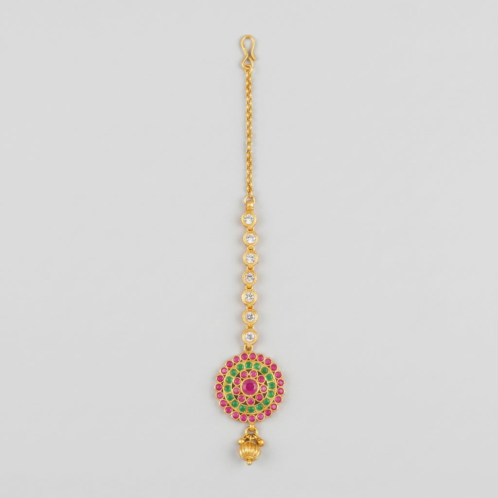 Meenakari Tikka gold maang tikka with pink green target pendant and crystal chain on gray background