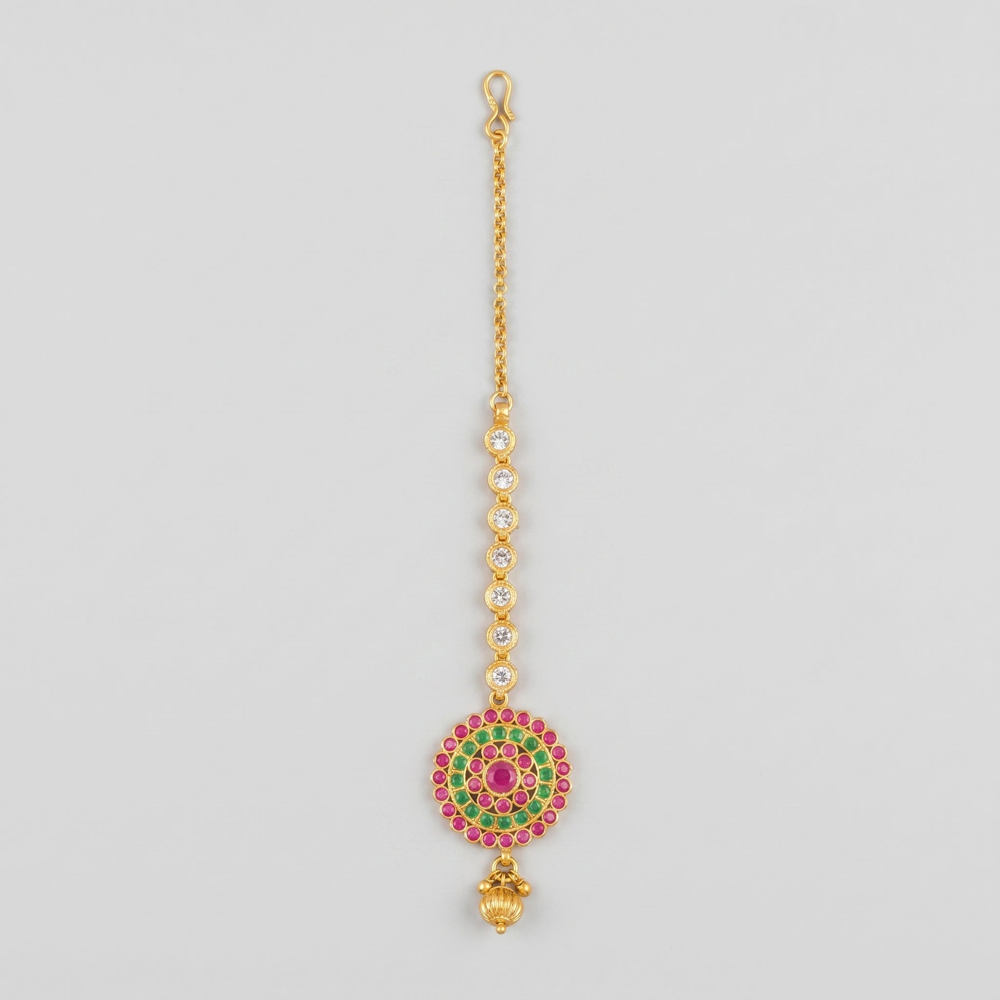 Meenakari Tikka gold maang tikka with pink green target pendant and crystal chain on gray background