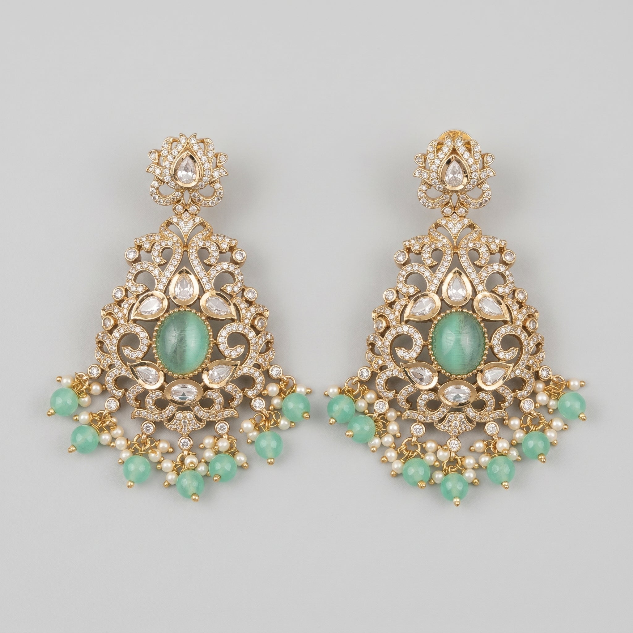 Zara Mint Earrings gold-tone chandelier earrings with mint green cabochon and pearl fringe on gray background