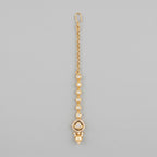 Noor Golden Tikka gold-tone maang tikka with pearl drop on gray background
