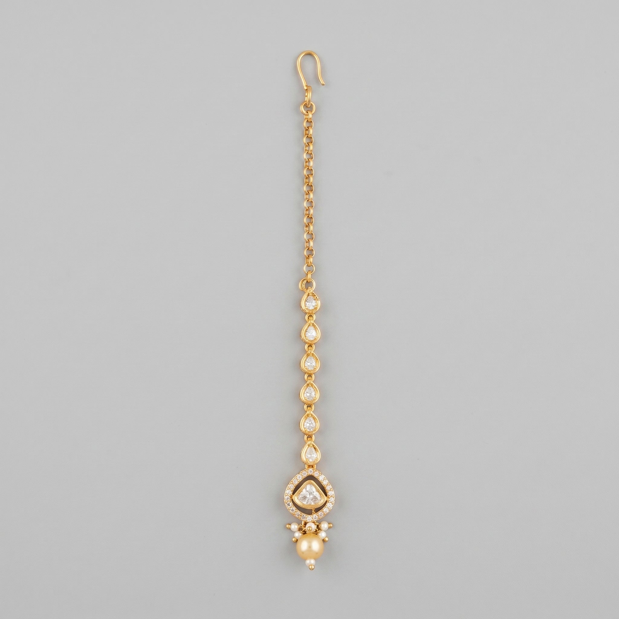 Noor Golden Tikka gold-tone maang tikka with pearl drop on gray background