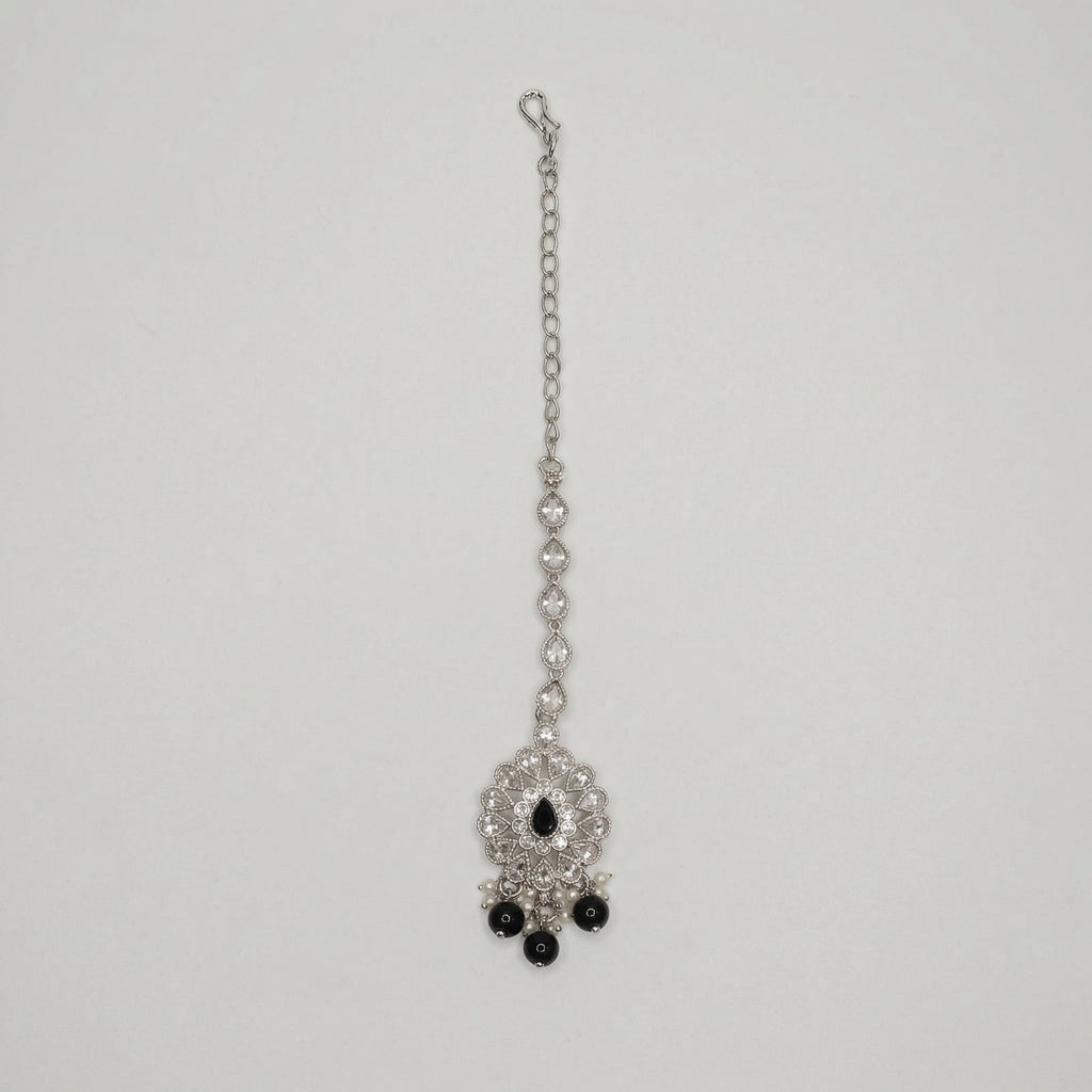 Sia Noir Tikka silver maang tikka with black center stone and black bead drops on gray background