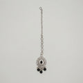 Sia Noir Tikka silver maang tikka with black center stone and black bead drops on gray background