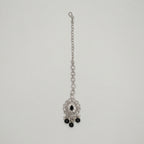 Sia Noir Tikka silver maang tikka with black center stone and black bead drops on gray background