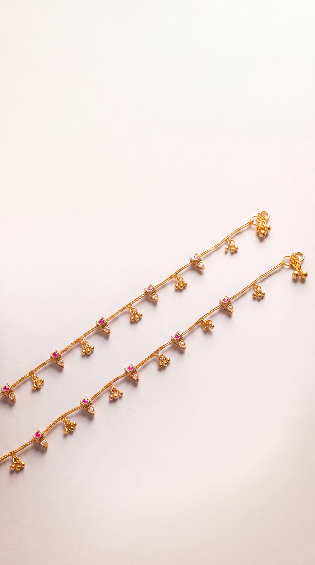 Mira Dewdrop Anklets clasp detail, gold-tone chain with tiny bells, clear pear stones, and pink accents
